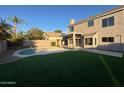 Lush backyard with artificial grass and a pool, perfect for relaxation and outdoor entertainment at 4216 E Tether Trl, Phoenix, AZ 85050