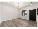 Elegant dining room with modern chandelier, wood-style floors and large window perfect for entertaining guests at 4216 E Tether Trl, Phoenix, AZ 85050