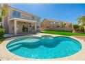 Inviting backyard pool and spa, perfect for relaxation with a covered patio and lush landscaping in the background at 4216 E Tether Trl, Phoenix, AZ 85050