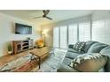 Cozy living room with a plush gray sofa, colorful rug, and bright natural light at 4620 N 68Th St # 111, Scottsdale, AZ 85251