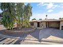 Charming single-story home with a mature tree and a well-manicured front yard at 734 S Edgewater Dr, Mesa, AZ 85208