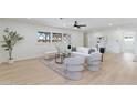 Sunlit living room showcasing neutral decor, hardwood floors, and a cozy seating arrangement at 800 W Erie St, Chandler, AZ 85225