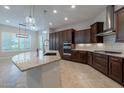 Spacious kitchen with a granite island, and rich cabinetry at 8180 W Silver Spring Way, Florence, AZ 85132