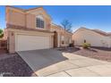 Charming two-story home featuring a tile roof, two car garage and low maintenance desert landscaping at 819 W Kyle E Ct, Gilbert, AZ 85233