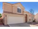 Charming two-story home featuring a tile roof, two car garage and low maintenance desert landscaping at 819 W Kyle E Ct, Gilbert, AZ 85233