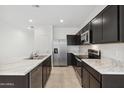 Beautiful kitchen featuring granite countertops, dark cabinetry, and stainless steel appliances for the home chef at 8452 W Clemente Way, Florence, AZ 85132