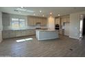 Spacious kitchen featuring granite countertops, stainless appliances and a large island at 8553 N 175Th Ln, Waddell, AZ 85355