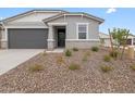 Charming single-story home with gray stucco, brick accents, with low maintenance desert landscaping at 8554 W Trenton Ct, Florence, AZ 85132