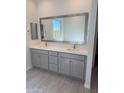 Bathroom with double sink vanity, modern fixtures, and ample counter space at 8561 N 175Th Ln, Waddell, AZ 85355