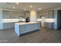 Spacious kitchen featuring an island, gray cabinets, stainless steel appliances, and modern countertops at 8561 N 175Th Ln, Waddell, AZ 85355