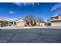 Inviting home with a two-car garage, mature landscaping, and a charming facade at 9404 W Pierson St, Phoenix, AZ 85037