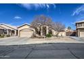 Inviting home with a two-car garage, mature landscaping, and a charming facade at 9404 W Pierson St, Phoenix, AZ 85037