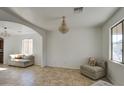 Bright living room featuring tile floors, a decorative chandelier, and a comfortable sofa at 1016 E Saddleback Pl, San Tan Valley, AZ 85143