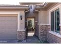 Close-up of front entrance featuring a brick facade and access to the home at 10657 E Evergreen St, Mesa, AZ 85207