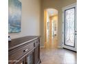 Welcoming foyer with tile flooring, wood accents and an arched entrance at 10657 E Evergreen St, Mesa, AZ 85207