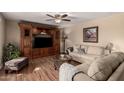 Cozy living room featuring wood floors, a comfortable couch and a large entertainment center at 11830 S Paiute St, Phoenix, AZ 85044