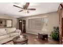 Comfortable living room with neutral color walls, wood floors, and plenty of natural light at 11830 S Paiute St, Phoenix, AZ 85044