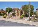 Inviting single-story home with desert landscaping, a wrought-iron gate, and an attached two-car garage at 12956 W Eagle Ridge Ln, Peoria, AZ 85383