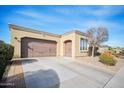 Spacious three car garage features large driveway and desert landscaping at 12956 W Eagle Ridge Ln, Peoria, AZ 85383