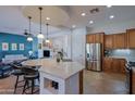 Kitchen island with seating, pendant lights and Stainless Steel appliances at 13054 W Big Oak St, Peoria, AZ 85383