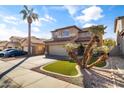 View of two-story home with desert landscaping, synthetic grass and a two car garage at 14309 W Weldon Ave, Goodyear, AZ 85395