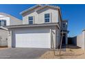 Charming home featuring a two-car garage, complemented by desert landscaping, and a sunny, blue sky at 1588 N Pueblo Dr, Apache Junction, AZ 85120