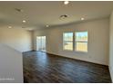 Open-concept living area with sliding glass doors and wood-look tile flooring offers seamless indoor-outdoor living at 1588 N Pueblo Dr, Apache Junction, AZ 85120