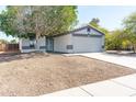 A cozy single-Gathering house with an attached garage and mature tree in the front yard at 1793 S Valley Dr, Apache Junction, AZ 85120