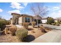 Beautiful desert landscaped front yard with walkway leading to the front door at 18382 N Arbor Dr, Maricopa, AZ 85138