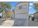 Two-story home with a two-car garage, neutral stucco and a paved driveway at 2013 E Dust Devil Dr, San Tan Valley, AZ 85143