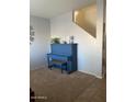 Cozy living area with a blue piano and neutral carpeting at 2013 E Dust Devil Dr, San Tan Valley, AZ 85143