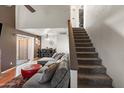 Inviting living space featuring a staircase, modern furnishings, and a view of the dining area at 222 W Brown Rd # 57, Mesa, AZ 85201