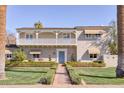 Charming two-story home with a balcony, manicured landscaping, and a brick pathway to the front door at 2233 N 9Th Ave, Phoenix, AZ 85007