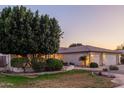 Beautiful home exterior with well-manicured lawn, mature trees, and a spacious two-car garage at 2625 W Oakland St, Chandler, AZ 85224