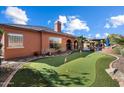 Private backyard features a putting green and outdoor living space at 3132 E Harwell Rd, Phoenix, AZ 85042