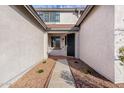 Covered entrance with decorative rock features and walkway leading up to a black front door at 32815 N Slate Creek Dr, San Tan Valley, AZ 85143