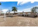 Exterior view showcases a single-story home with low wall and desert landscaping at 3611 W Hazelwood St, Phoenix, AZ 85019