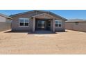 The backyard features a covered patio, desert landscaping, and sliding glass doors leading inside at 3850 N Camden Dr, Florence, AZ 85132