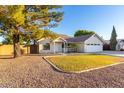 Inviting single-story home with a lush front lawn and mature trees at 3957 E Adobe St, Mesa, AZ 85205