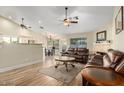 Cozy living room featuring hardwood floors, ceiling fans, and a decorative fireplace at 3957 E Adobe St, Mesa, AZ 85205