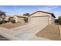 Attractive single-Gathering residence showcasing a spacious driveway and low-water desert landscaping at 43556 W Colby Dr, Maricopa, AZ 85138