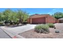 Wide front of single-story house with long driveway and desert landscaping at 43573 W Blazen Trl, Maricopa, AZ 85138