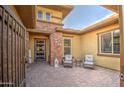 Inviting front courtyard features cozy seating and a decorative welcome sign at 4750 S Rhodium Ln, Mesa, AZ 85212