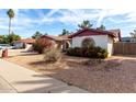 A single-story house with desert landscaping and a brick archway entrance at 5043 W Christy Dr, Glendale, AZ 85304