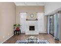 Bright living room featuring a stone fireplace, high ceiling, and sliding glass doors at 5726 N 10Th St # 5, Phoenix, AZ 85014