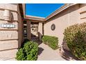 Charming walkway leading to the front entrance with neatly trimmed bushes, desert landscaping, and house number clearly displayed at 5902 S Amberwood Dr, Sun Lakes, AZ 85248