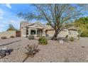 Inviting single-story home with desert landscaping and a two-car garage at 5940 E Taunus Cir, Mesa, AZ 85215