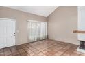 Open-concept living room featuring tile floors, natural light, and a cozy fireplace at 609 E Mesquite Cir # D131, Tempe, AZ 85288