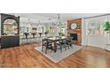 Open-concept dining room featuring a rustic wood table and accents, seamlessly connected to a stylish, modern kitchen at 6440 E Jean Dr, Scottsdale, AZ 85254