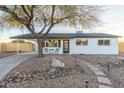 Charming white brick home featuring desert landscaping and an attached carport at 6601 E Latham St, Scottsdale, AZ 85257